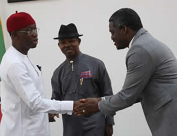 Governor Okowa in a handshake during DSCHC establishment proceedings